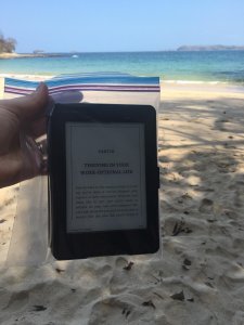 Reading Kindle beach sand