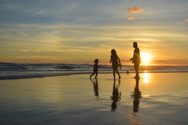 family beach sunset water