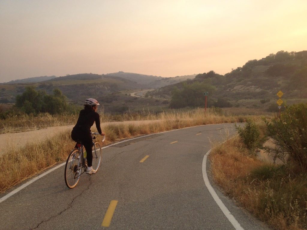 woman biking sunset